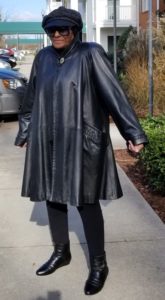 Dressed in leather coat and leggings